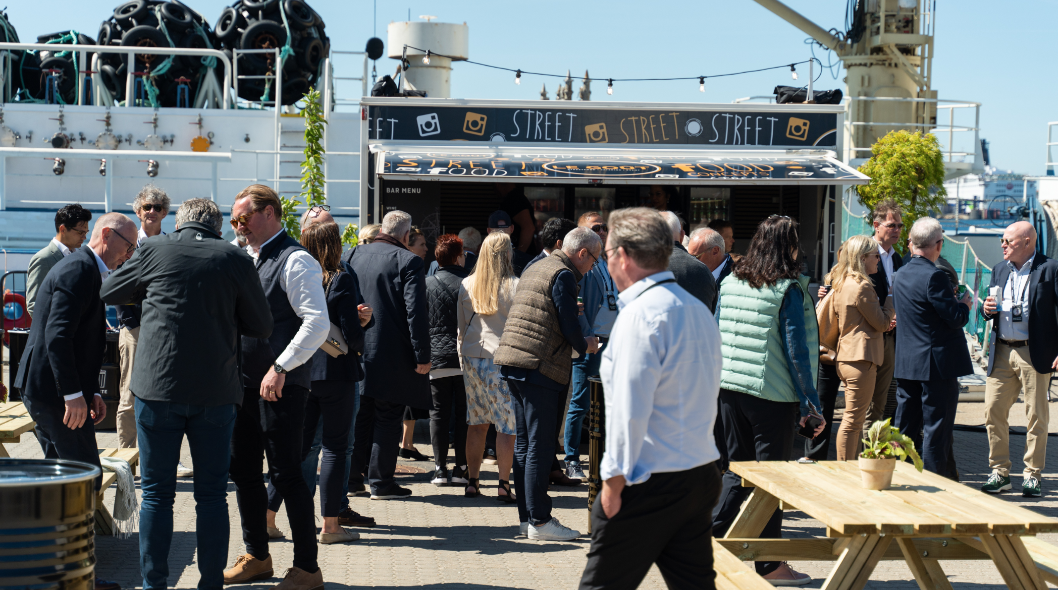Branded food truck with guests at a corporate event by the harbour